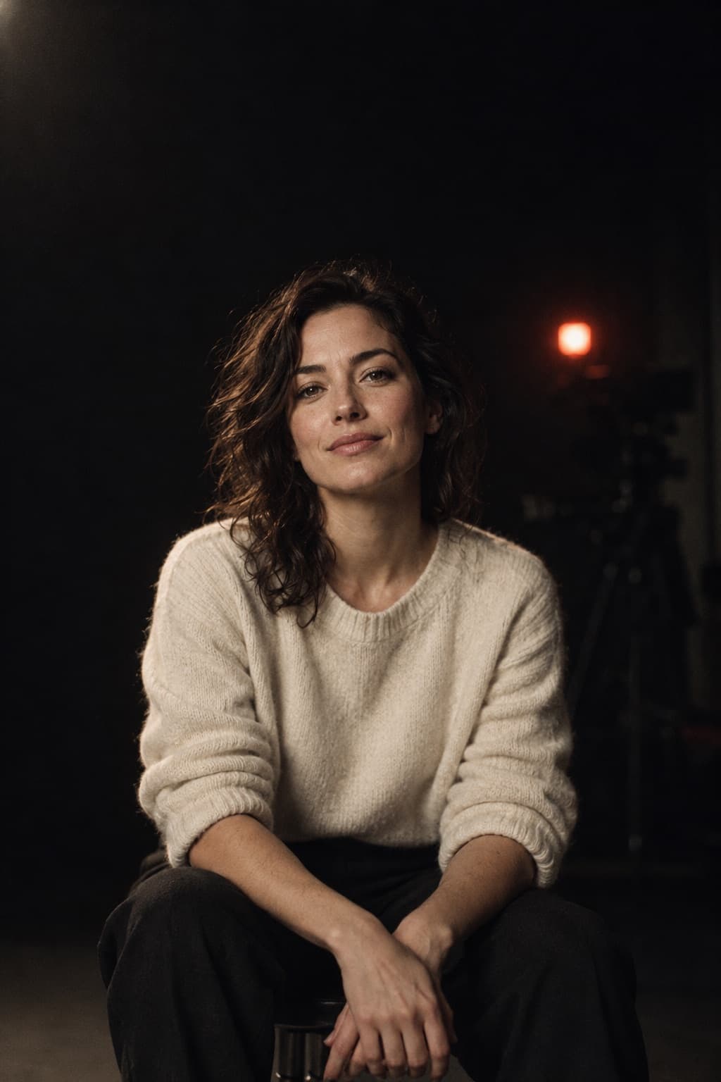 A creator's AI twin, seated in a dark studio